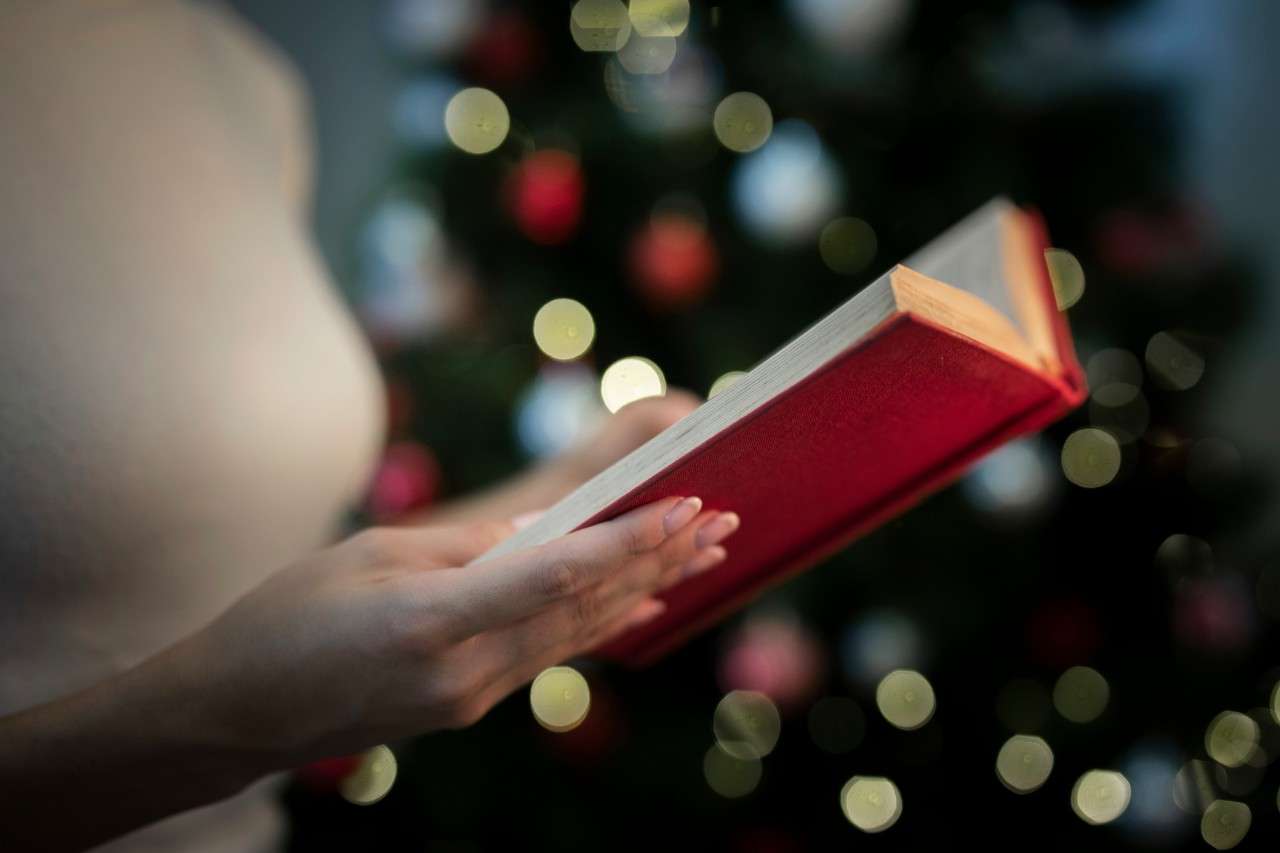 close-up-woman-holding-book-with-stories-christmas (1)
