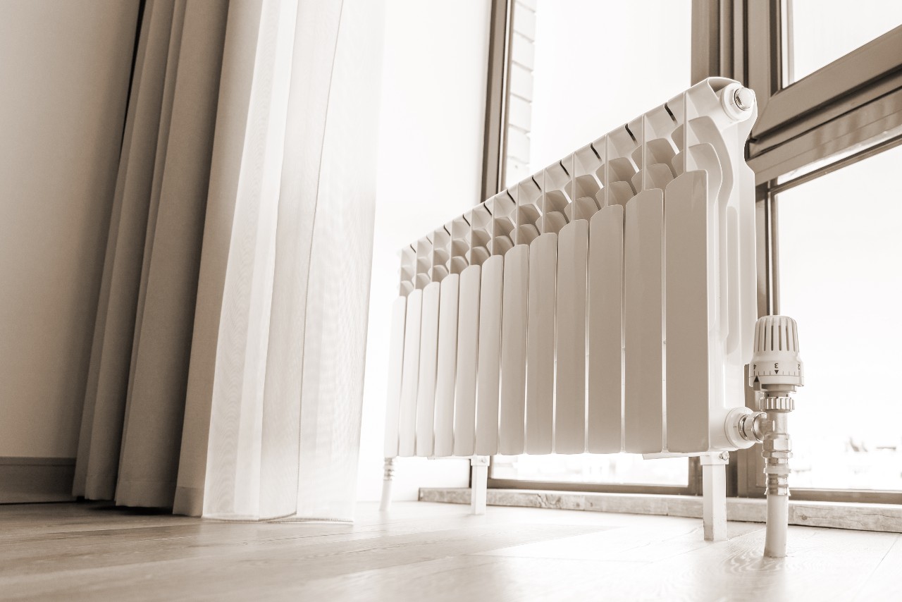 white-big-radiator-near-window-modern-room-sepia-toning (1)