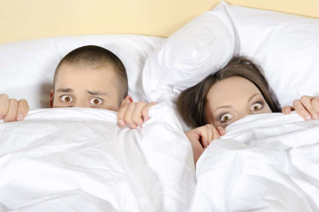 Scared couple with eyes wide open