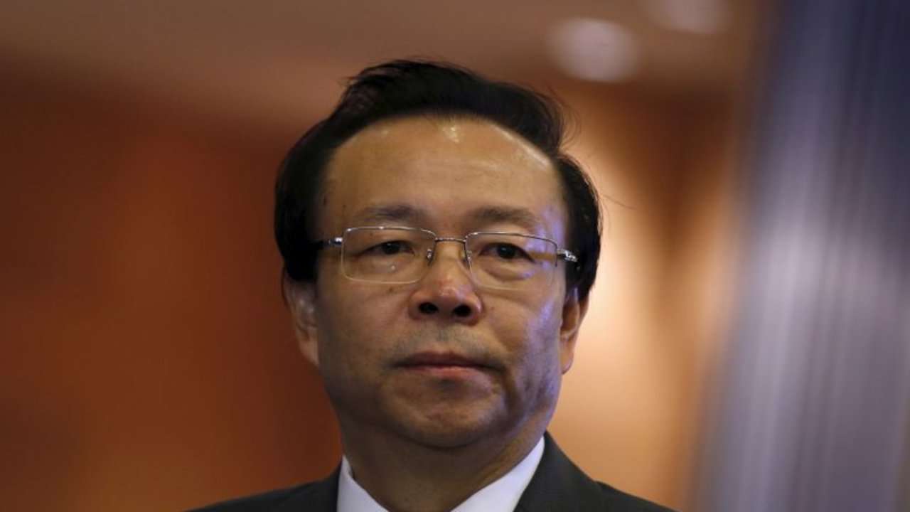 China Huarong Asset Management Co Chairman Lai Xiaomin listens to a question from a reporter during the debut of the company at the Hong Kong Exchanges in Hong Kong