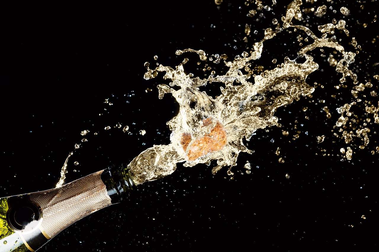 Разбитое шампанское. Шампанское брызги. Бутылка шампанского с брызгами. Брызги шампанского на черном фоне. Фон брызги шампанского.
