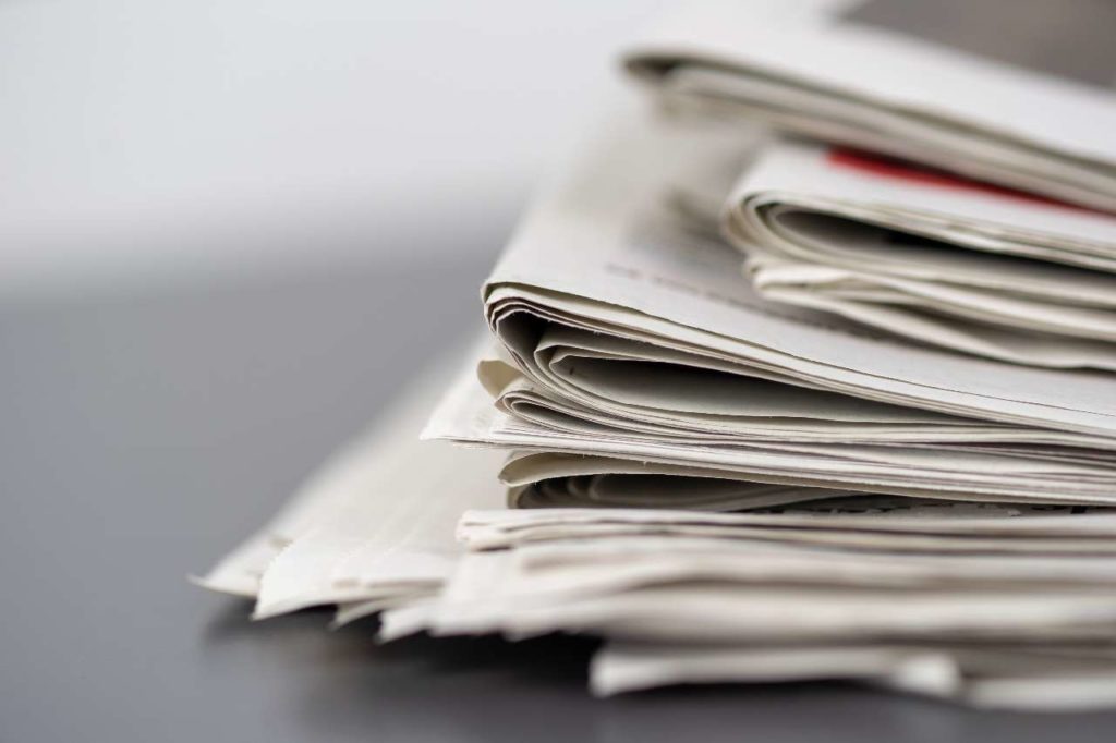 closeup-shot-several-newspapers-stacked-top-each-other-2-2-1-1