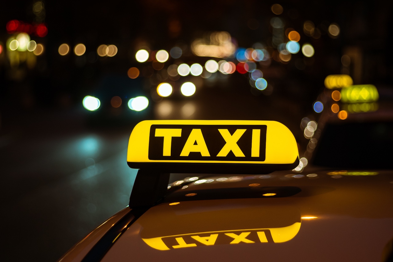 yellow-black-sign-taxi-placed-top-car-night-2