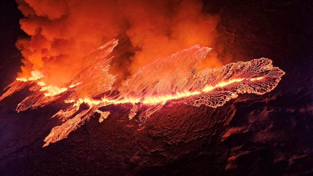 FILE PHOTO: A volcano spews lava and smoke as it erupts in Grindavik
