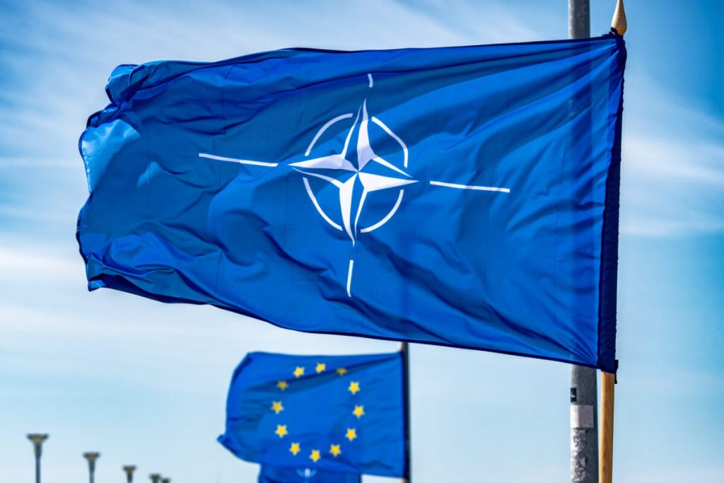 260704121423_NATO-flag-waiving-on-a-flagpole-1200×800